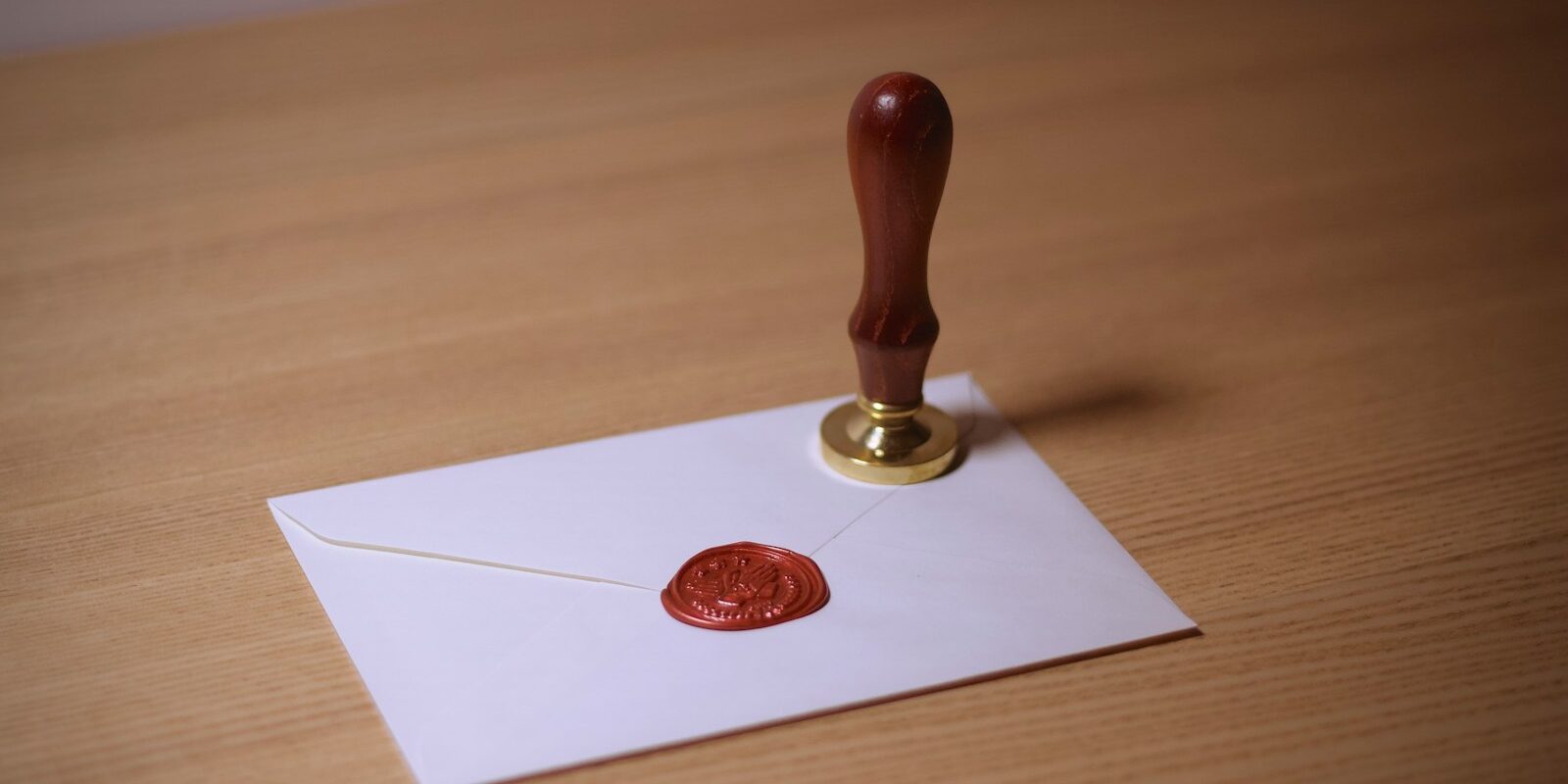 brown wooden stamper on envelope